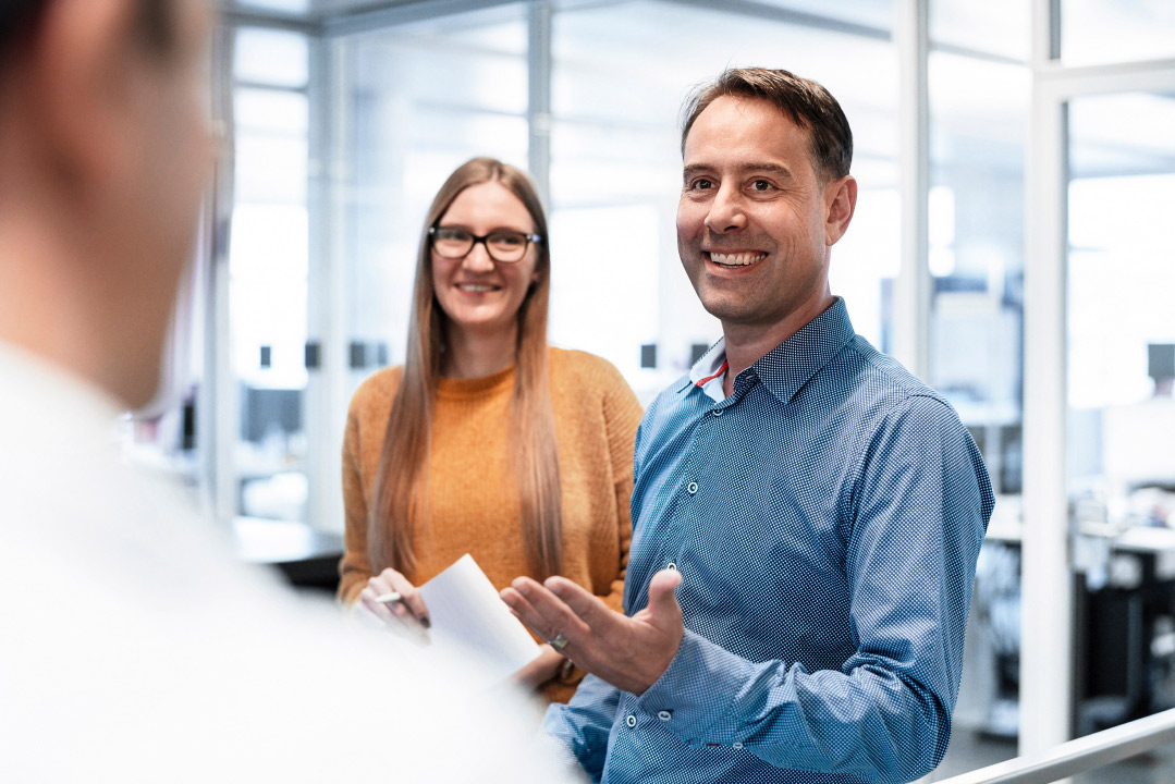 three colleagues mid discussion